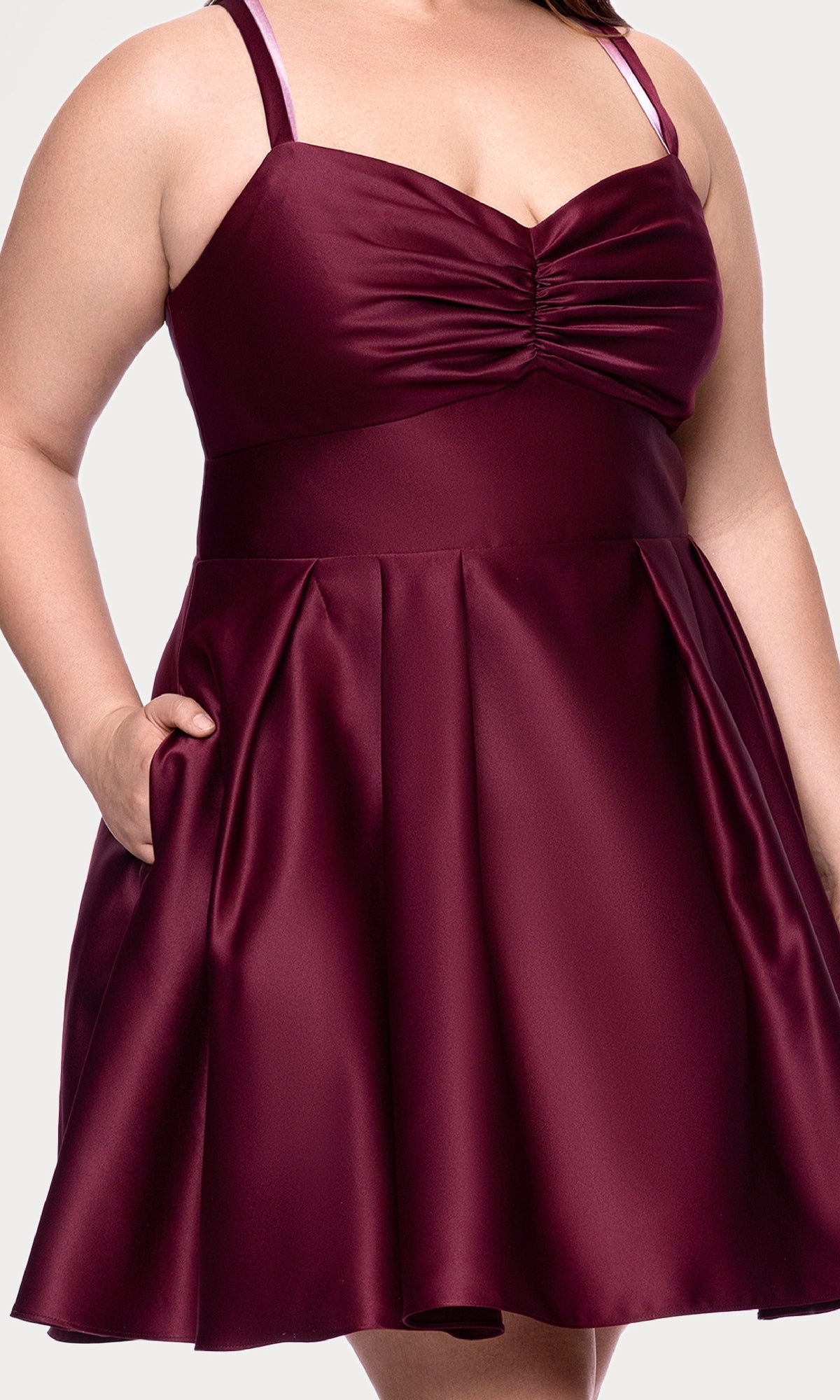 A person is shown from shoulders to mid-thigh wearing the Plus Short Wine Hoco Dress: Blondie Nites 4927BNW, a sleeveless wine red party dress with a fitted bodice, ruched front detail, and flared skirt.